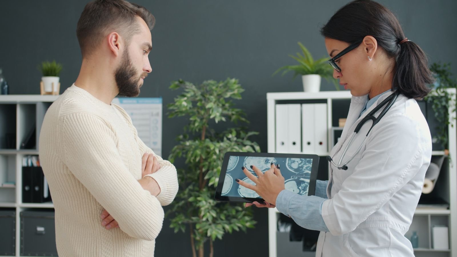 Single Port Robotic Surgery - doctor reviewing imaging with a patient before choosing the surgical route