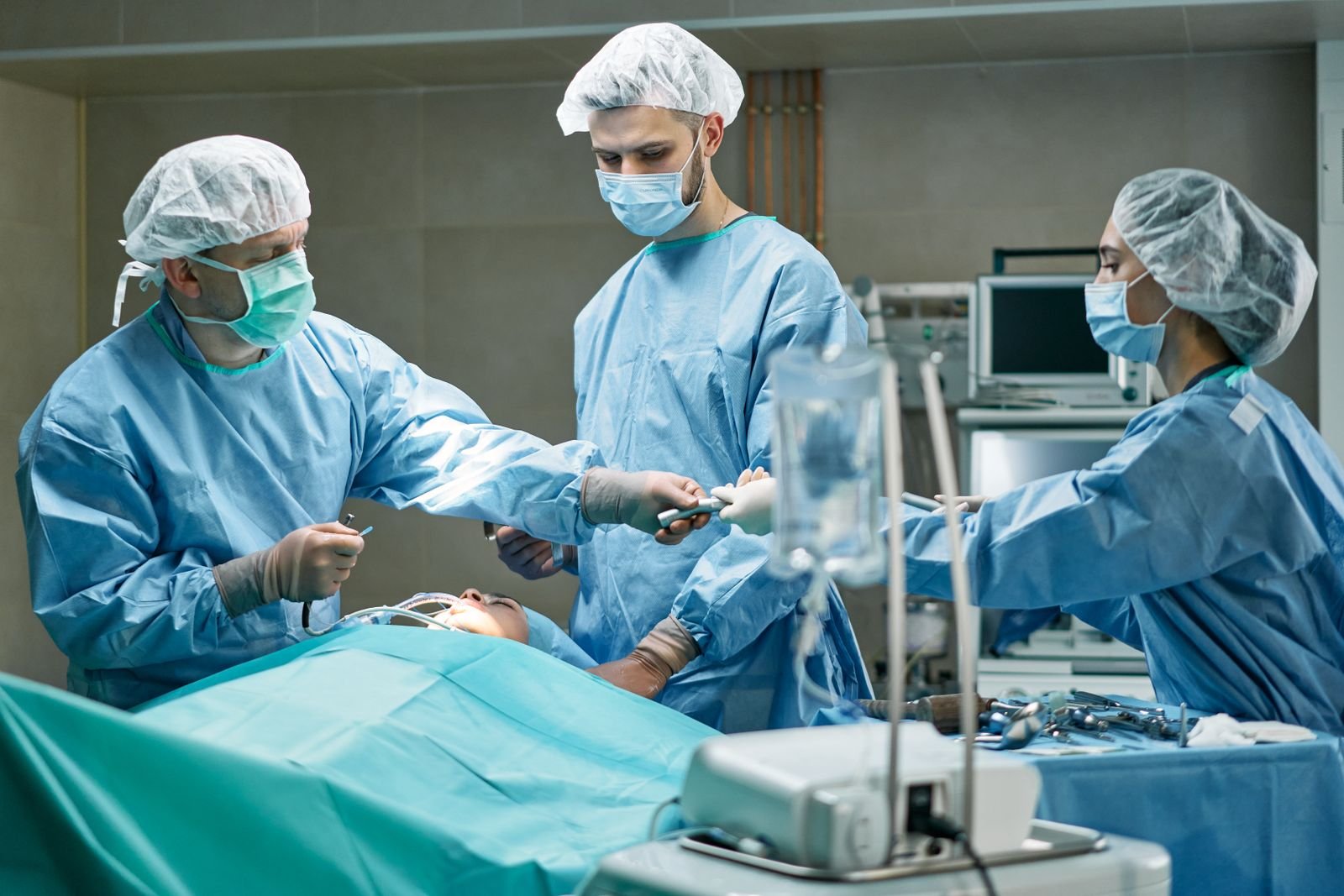 Single Port Robotic Surgery - surgical team during a prostate operation with the patient lying almost flat