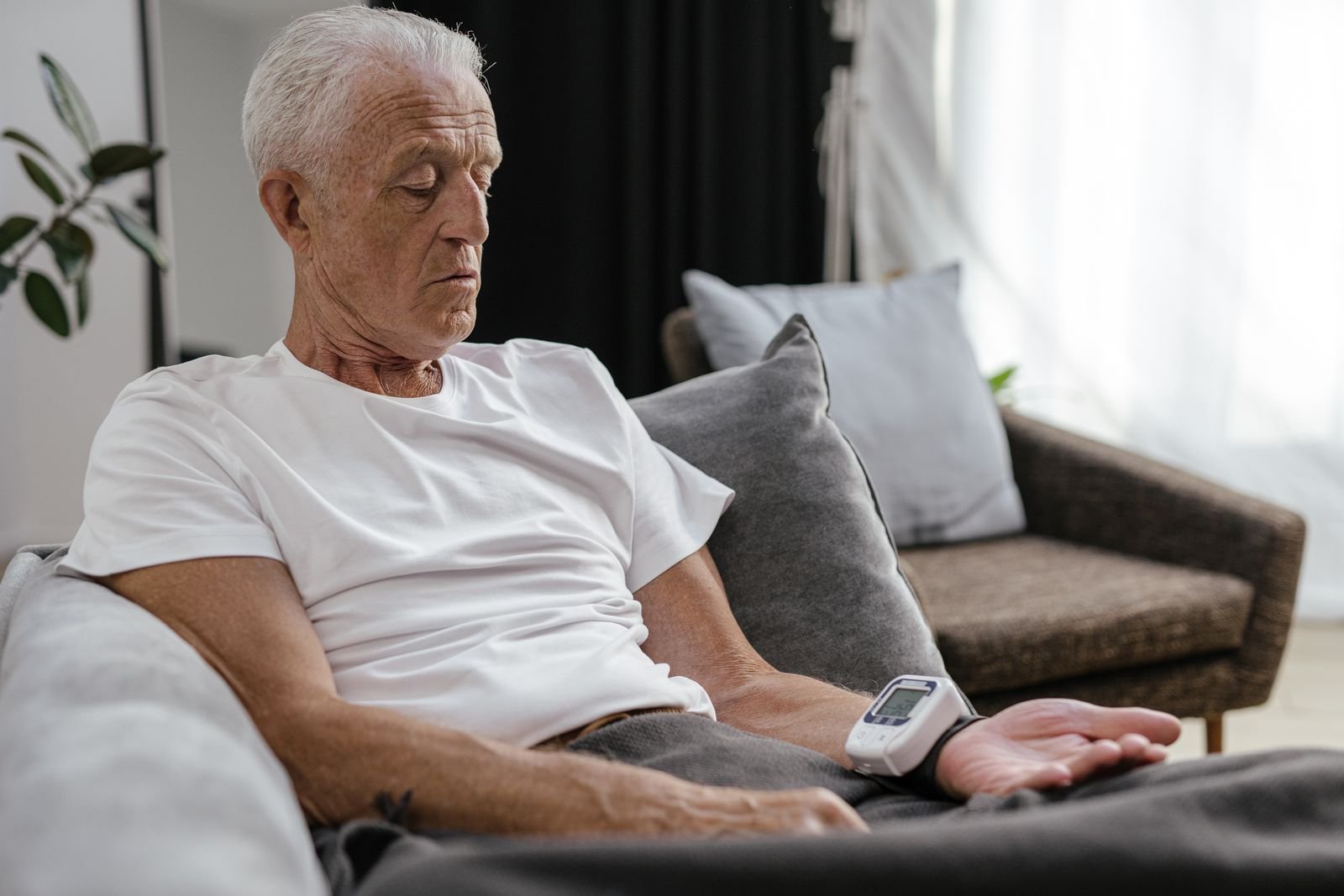 Single Port Robotic Surgery - older man checking his blood pressure at home