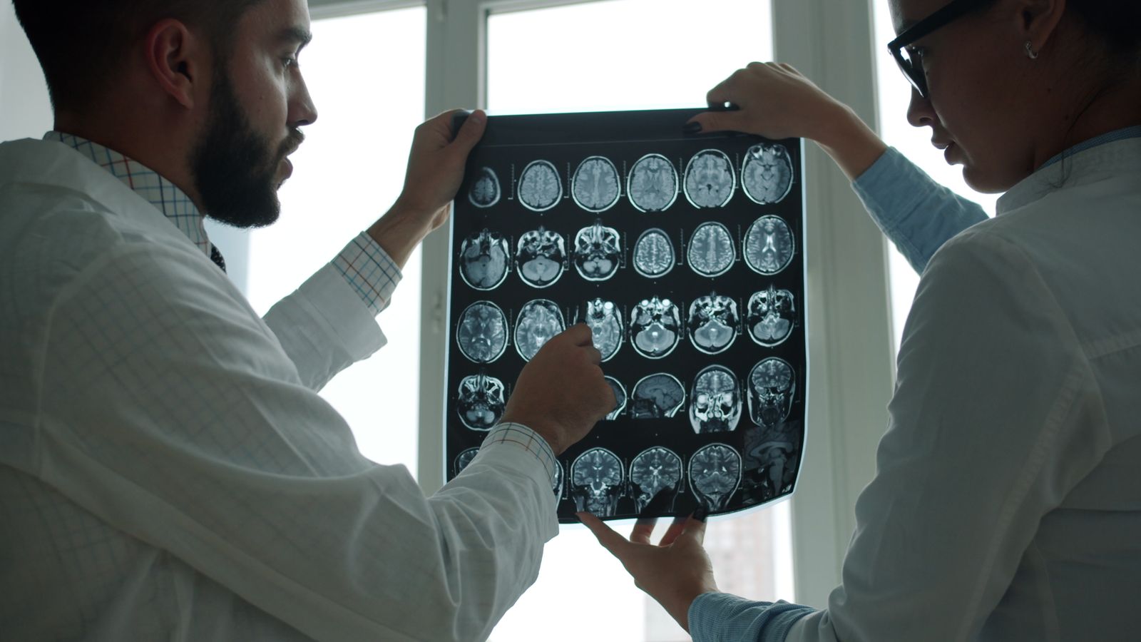 Single Port Robotic Surgery - two doctors reviewing MRI scans to plan the route