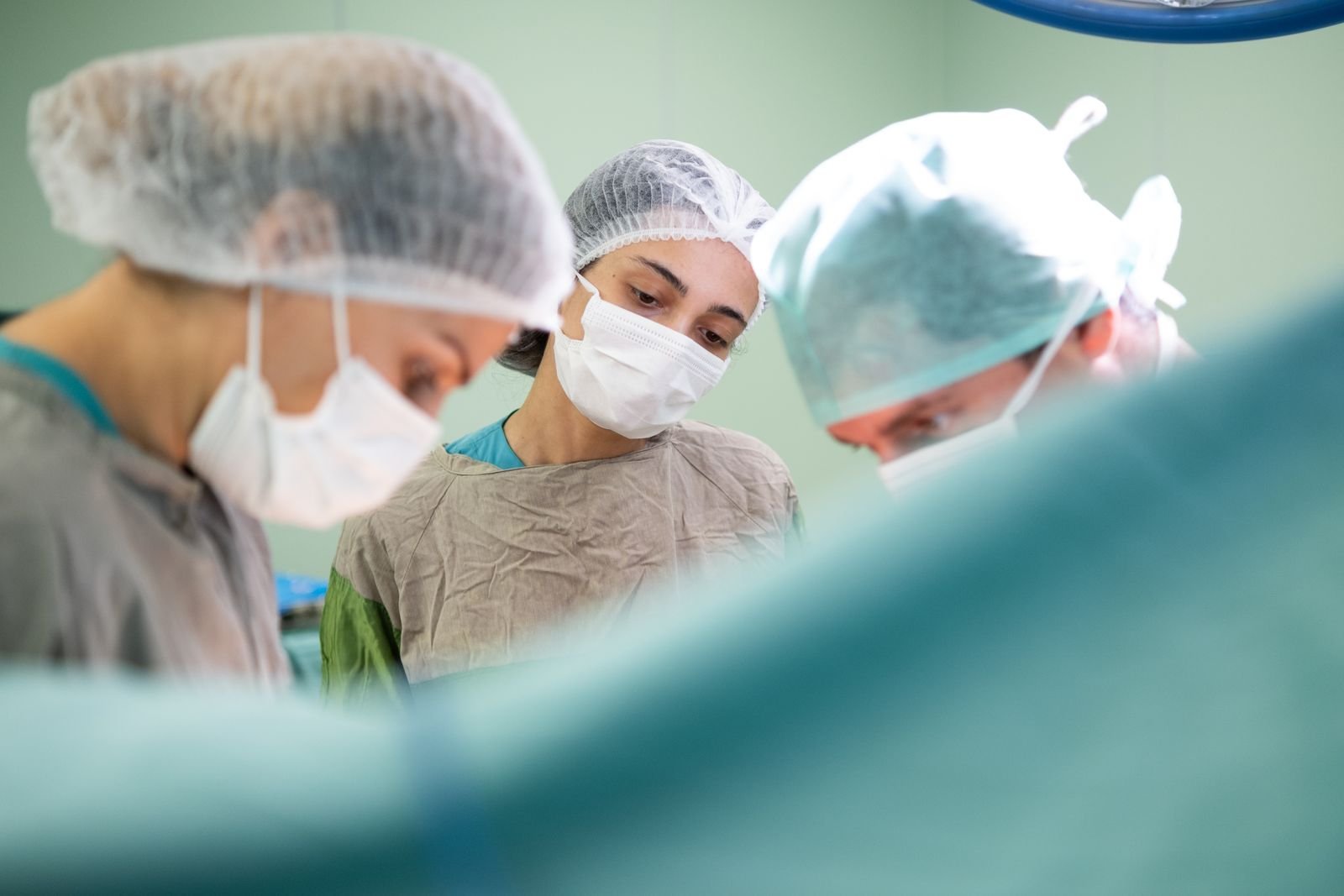 Single Port Robotic Surgery - surgeons concentrating closely during an operation