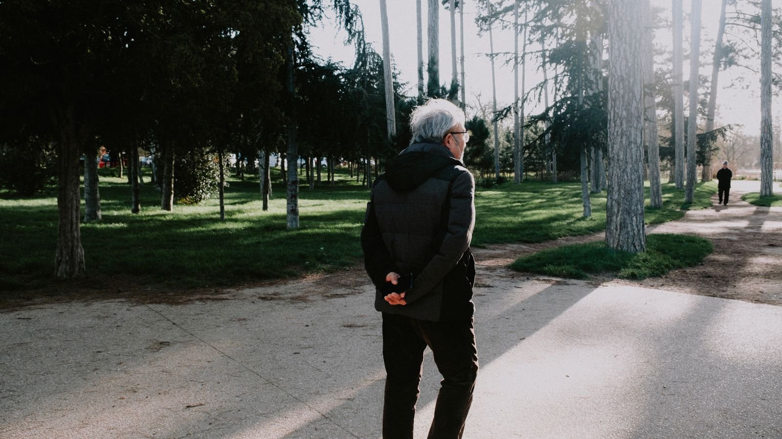 Single Port Robotic Surgery - older man walking in a park during recovery