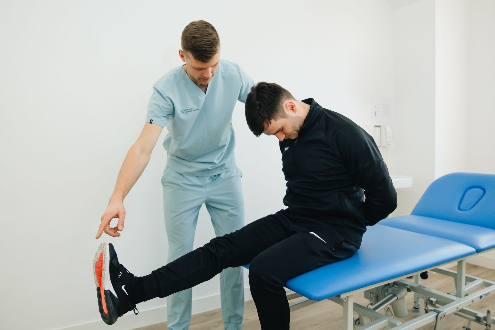 Single Port Robotic Surgery - physiotherapist guiding a male patient through exercises