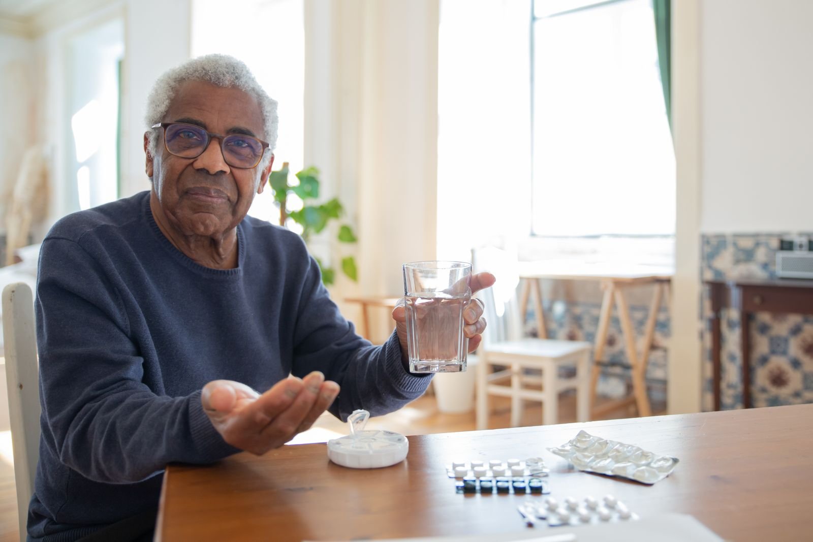 Single Port Robotic Surgery - older man with a glass of water at home